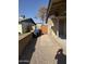 Backyard with a gravel pathway, cinder block wall and a wooden gate for privacy at 1841 N Wilbur Cir, Mesa, AZ 85201