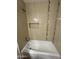 This bathroom features a tiled tub with a shower head and built-in shelving at 1841 N Wilbur Cir, Mesa, AZ 85201