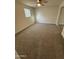 Bright bedroom with neutral carpet, ceiling fan, and a sunlit window with a view at 1841 N Wilbur Cir, Mesa, AZ 85201