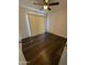 Bedroom features hardwood floors, a ceiling fan, and bright window coverings at 1841 N Wilbur Cir, Mesa, AZ 85201