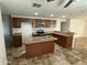 Well-equipped kitchen featuring an island, wooden cabinets, and stainless steel appliances at 1841 N Wilbur Cir, Mesa, AZ 85201