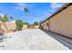 Backyard featuring a large concrete area leading to a wooden gate at 2652 N 143Rd Dr, Goodyear, AZ 85395