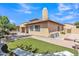 Exterior view of the home with a well-manicured lawn and covered patio at 2652 N 143Rd Dr, Goodyear, AZ 85395