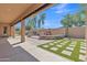Backyard view of the built in barbeque, artificial turf and desert landscaping at 2652 N 143Rd Dr, Goodyear, AZ 85395