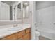 Bathroom featuring white countertop, wood cabinets, tile flooring, and tub with white backsplash at 2652 N 143Rd Dr, Goodyear, AZ 85395