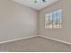 A cozy bedroom with neutral carpet and a window offering natural light at 2652 N 143Rd Dr, Goodyear, AZ 85395