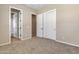 Bedroom with carpet, closet and a doorway leading to another room at 2652 N 143Rd Dr, Goodyear, AZ 85395