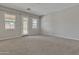 Neutral bedroom with carpeted floor, light gray walls, and a door leading to the exterior at 2652 N 143Rd Dr, Goodyear, AZ 85395