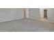 Bedroom with carpeted floor, neutral walls, and an open doorway to a tiled bathroom at 2652 N 143Rd Dr, Goodyear, AZ 85395