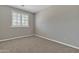 Bedroom with a window offering natural light and neutral carpet at 2652 N 143Rd Dr, Goodyear, AZ 85395