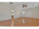 Bright and airy bedroom with wood floors, ceiling fan, and ensuite bathroom access at 2652 N 143Rd Dr, Goodyear, AZ 85395