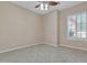 A secondary bedroom featuring tile flooring and window with shutter shades at 2652 N 143Rd Dr, Goodyear, AZ 85395