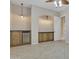 Bonus room featuring wood cabinets, tile flooring, refrigerator and decorative lighting at 2652 N 143Rd Dr, Goodyear, AZ 85395