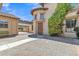 Beautiful courtyard with custom brickwork, mature landscaping, and a charming architectural design at 2652 N 143Rd Dr, Goodyear, AZ 85395