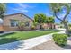 Inviting home showcasing lush green lawn, mature trees, and a well-maintained exterior at 2652 N 143Rd Dr, Goodyear, AZ 85395