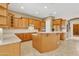 Spacious kitchen with wooden cabinets, granite countertops, kitchen island, and stainless steel appliances at 2652 N 143Rd Dr, Goodyear, AZ 85395