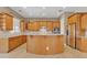 Spacious kitchen with granite countertops, island, ample cabinet space, and modern appliances at 2652 N 143Rd Dr, Goodyear, AZ 85395