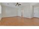 Spacious living room featuring wood flooring and natural light from a bathroom doorway at 2652 N 143Rd Dr, Goodyear, AZ 85395