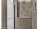 Modern walk-in shower with gray tile and a rainfall shower head at 2652 N 143Rd Dr, Goodyear, AZ 85395