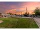 A large backyard with a lush lawn, storage shed, and block wall for privacy at 332 S 83Rd Pl, Mesa, AZ 85208