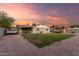 Home featuring a spacious backyard with gravel and grass, and a privacy wall at 332 S 83Rd Pl, Mesa, AZ 85208
