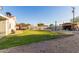 Backyard featuring a grass area, shed, privacy walls, and a gravel perimeter at 332 S 83Rd Pl, Mesa, AZ 85208
