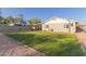 Lawn view of the backyard with gravel, landscaping and a covered patio at 332 S 83Rd Pl, Mesa, AZ 85208