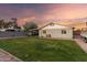 Backyard featuring a large, grassy area, privacy wall, shed, and covered parking at 332 S 83Rd Pl, Mesa, AZ 85208