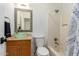 Bathroom featuring granite counters, vanity sink, shower, and decorative mirror at 332 S 83Rd Pl, Mesa, AZ 85208