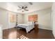 Bright bedroom features hardwood floors, a ceiling fan, and lots of natural light at 332 S 83Rd Pl, Mesa, AZ 85208