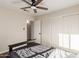 Bright bedroom featuring a ceiling fan, closet, and doorway to another room at 332 S 83Rd Pl, Mesa, AZ 85208