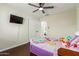 This bedroom has hardwood floors, a ceiling fan, and a closet at 332 S 83Rd Pl, Mesa, AZ 85208