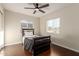 Comfortable bedroom features hardwood floors, a ceiling fan, and a bright window at 332 S 83Rd Pl, Mesa, AZ 85208