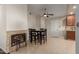 Charming dining room features a fireplace, tile floors, and a ceiling fan at 332 S 83Rd Pl, Mesa, AZ 85208