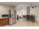 Open-concept kitchen features stainless steel appliances and flows into the dining area at 332 S 83Rd Pl, Mesa, AZ 85208