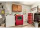 Laundry room featuring washer, dryer, water heater, cabinet, and a door leading outside at 332 S 83Rd Pl, Mesa, AZ 85208