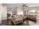 Spacious living room with hardwood floors, a large sectional sofa, and views of the kitchen at 332 S 83Rd Pl, Mesa, AZ 85208