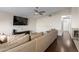 Comfortable living room with hardwood floors, a cozy couch, TV, and a ceiling fan at 332 S 83Rd Pl, Mesa, AZ 85208