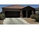 Single-story home featuring a tile roof, attached garage, and low-maintenance desert landscaping at 3796 N 298Th Ln, Buckeye, AZ 85396