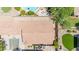 An aerial view showcases the home's roof, a paved driveway, and an outdoor living area with a firepit at 3898 E Palmer St, Gilbert, AZ 85298