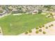 A spacious community park includes open green spaces, a volleyball court, and a playground, perfect for families at 3898 E Palmer St, Gilbert, AZ 85298