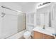 Bright bathroom with a tub/shower combination, cabinet, and vanity with sink at 3898 E Palmer St, Gilbert, AZ 85298