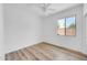 Inviting bedroom with natural light, a ceiling fan, and elegant wood-style flooring at 3898 E Palmer St, Gilbert, AZ 85298
