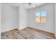 Bright bedroom features a ceiling fan, a window with natural light, and wood-look flooring at 3898 E Palmer St, Gilbert, AZ 85298