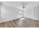Spacious bedroom with wood floors, ceiling fan and natural light from a window at 3898 E Palmer St, Gilbert, AZ 85298