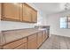 Bright kitchen featuring tile counters, wood cabinets, and updated appliances at 3898 E Palmer St, Gilbert, AZ 85298