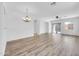 Bright living room featuring light wood floors, ample windows, and a decorative chandelier at 3898 E Palmer St, Gilbert, AZ 85298