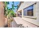 A paved outdoor patio is surrounded by garden greenery and has a covered area at 3898 E Palmer St, Gilbert, AZ 85298