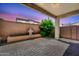 Covered patio featuring beautiful pavers, a serene fountain, and lush landscaping, bathed in the warm glow of sunset at 3898 E Palmer St, Gilbert, AZ 85298