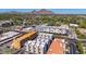 An aerial shot of modern apartment buildings and lush landscaping with a mountain backdrop on a clear, sunny day at 4220 N 32Nd St # 14, Phoenix, AZ 85018